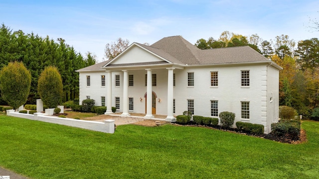 greek revival house featuring a front lawn