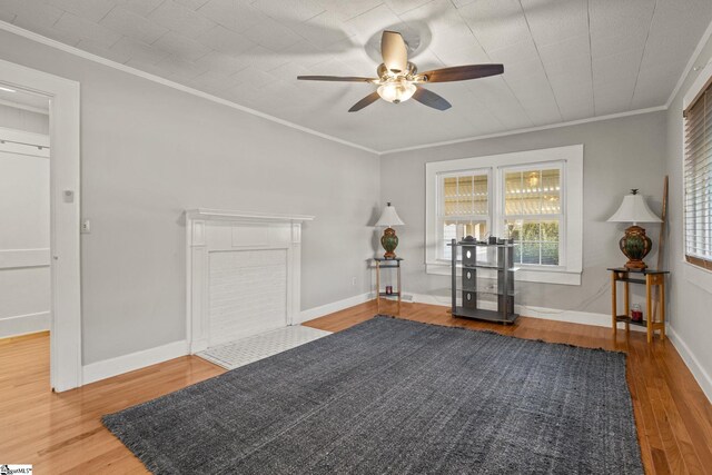 unfurnished room with hardwood / wood-style floors, ceiling fan, and crown molding