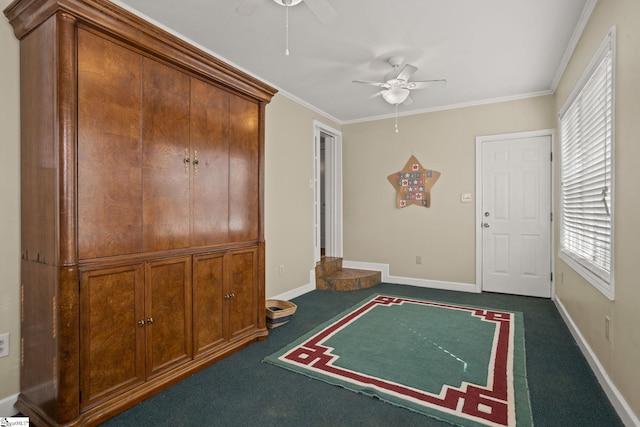 carpeted entryway with ceiling fan and ornamental molding