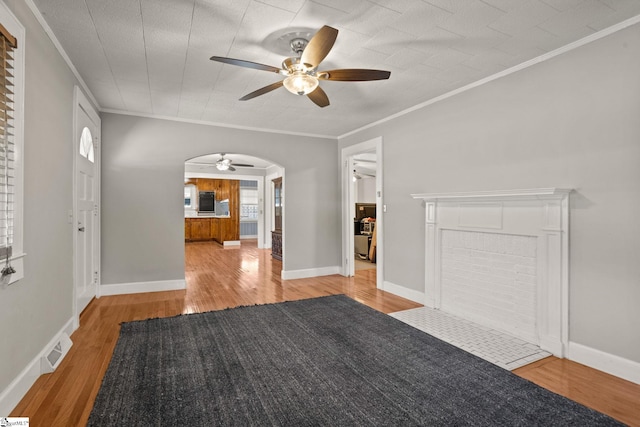 interior space featuring crown molding, ceiling fan, and light hardwood / wood-style floors