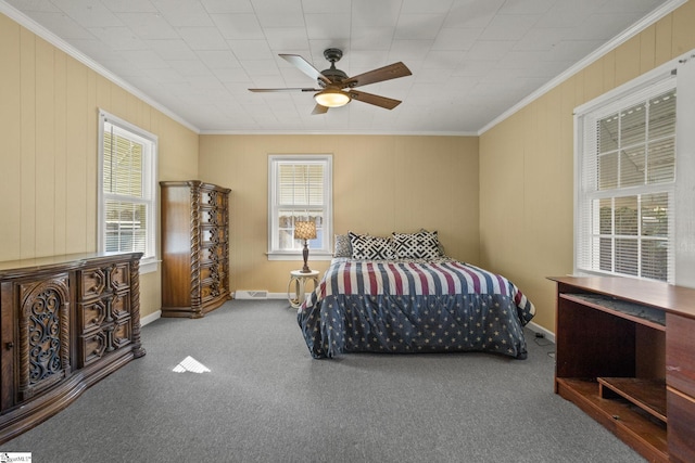 carpeted bedroom featuring ceiling fan and crown molding