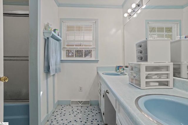 bathroom featuring vanity, a shower with door, and ornamental molding