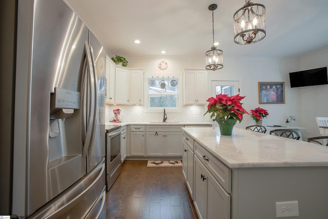 kitchen featuring ornamental molding, a kitchen island, dark hardwood / wood-style flooring, white cabinetry, and stainless steel appliances