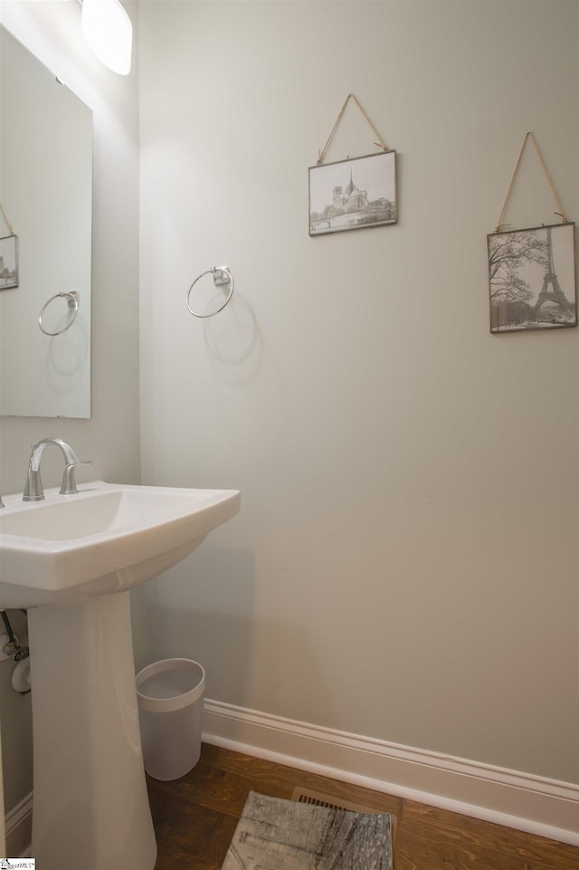 bathroom featuring wood-type flooring and sink