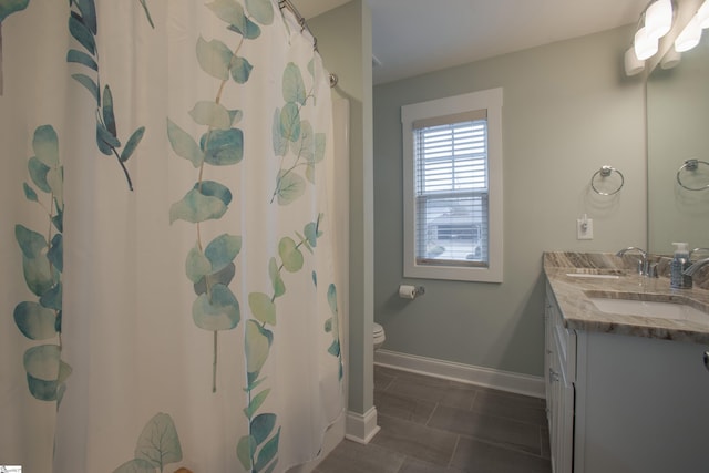 bathroom featuring walk in shower, vanity, and toilet