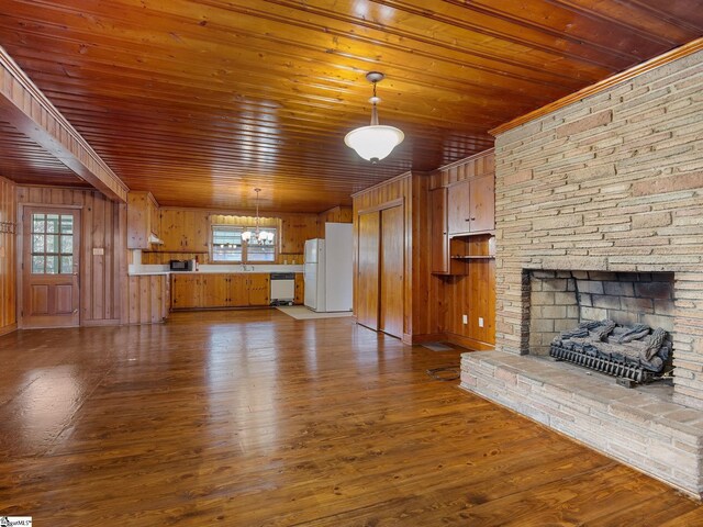 unfurnished living room featuring wooden ceiling, plenty of natural light, and hardwood / wood-style floors