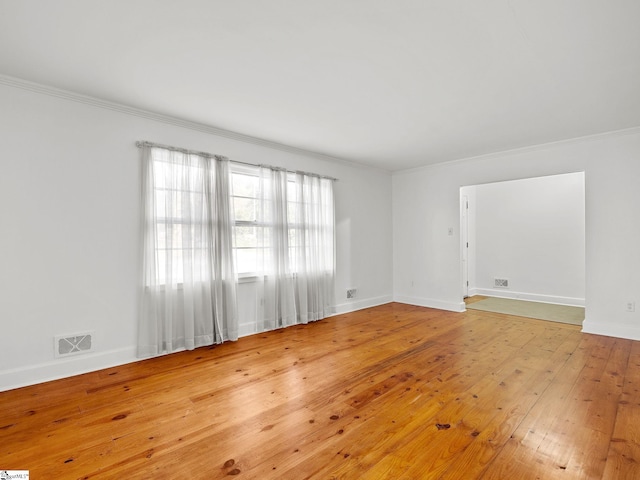 spare room with hardwood / wood-style floors and ornamental molding