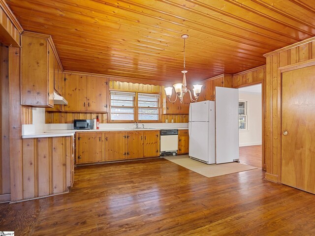 kitchen with a chandelier, white appliances, light hardwood / wood-style floors, and hanging light fixtures