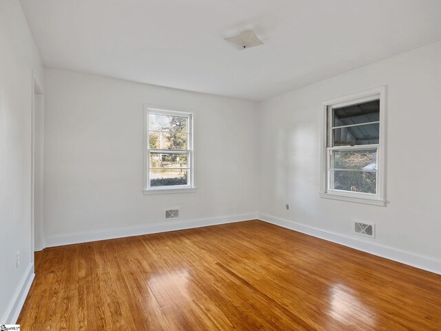 unfurnished room with wood-type flooring