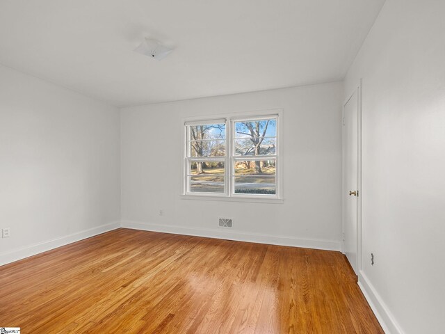 unfurnished room with light hardwood / wood-style floors