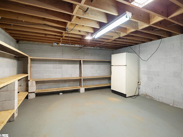 basement featuring white fridge