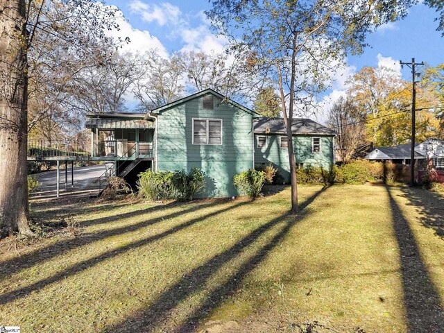 view of property exterior featuring a lawn