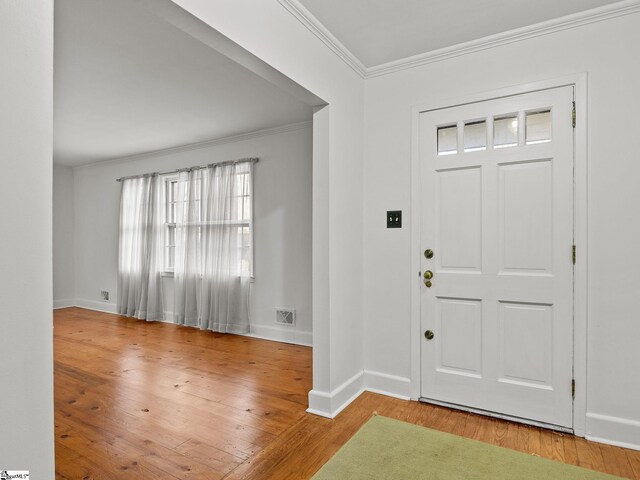 entryway with light hardwood / wood-style flooring and ornamental molding