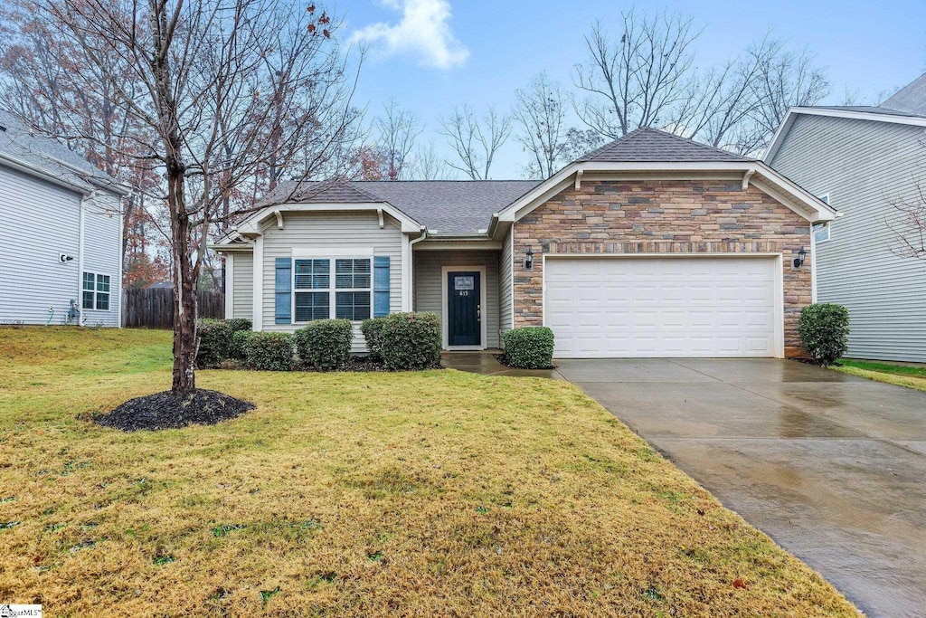 view of front facade with a front yard and a garage