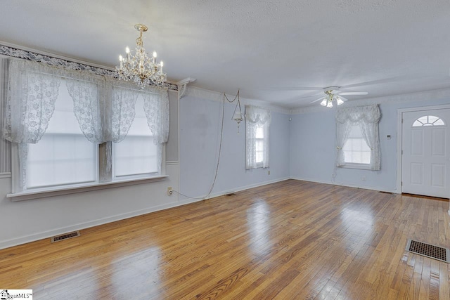 interior space featuring hardwood / wood-style floors and ceiling fan with notable chandelier