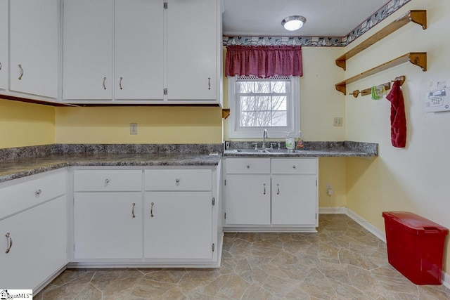 kitchen with white cabinetry and sink