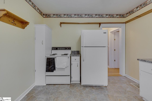 kitchen with white appliances and white cabinetry