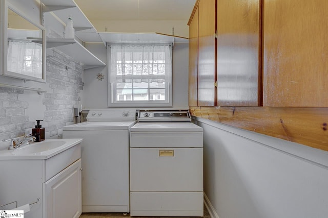 laundry area featuring washing machine and dryer and sink