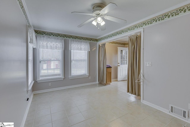 spare room with crown molding, ceiling fan, and light tile patterned floors