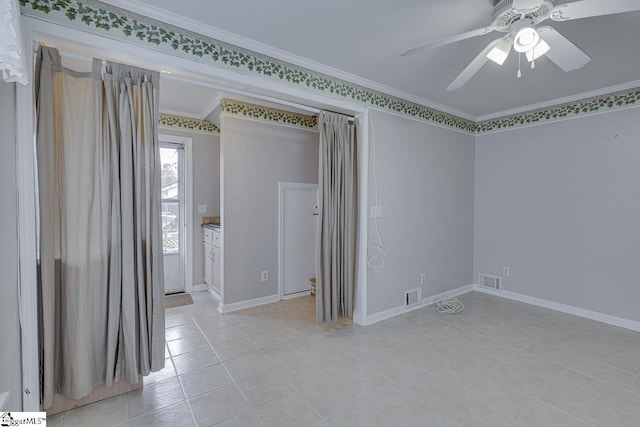 empty room with ceiling fan and crown molding