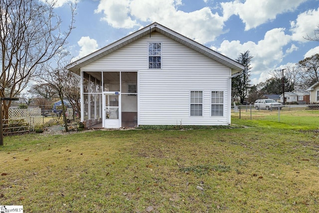 back of house featuring a sunroom and a yard