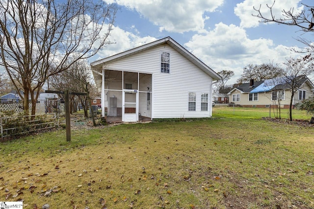 rear view of house with a lawn