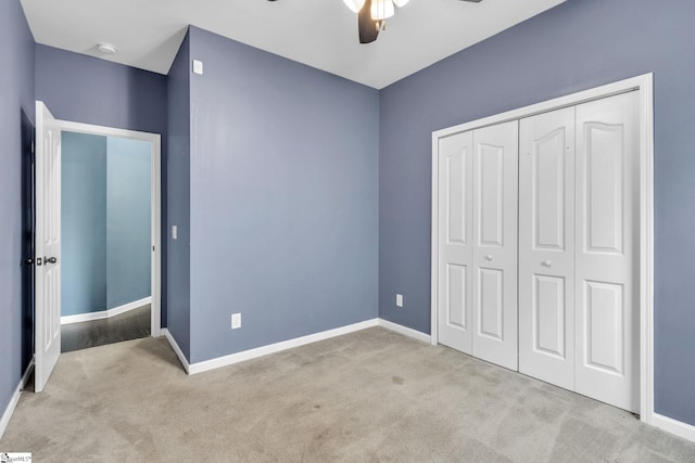 unfurnished bedroom featuring ceiling fan, a closet, and light colored carpet