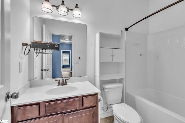 full bathroom featuring washtub / shower combination, vanity, and toilet