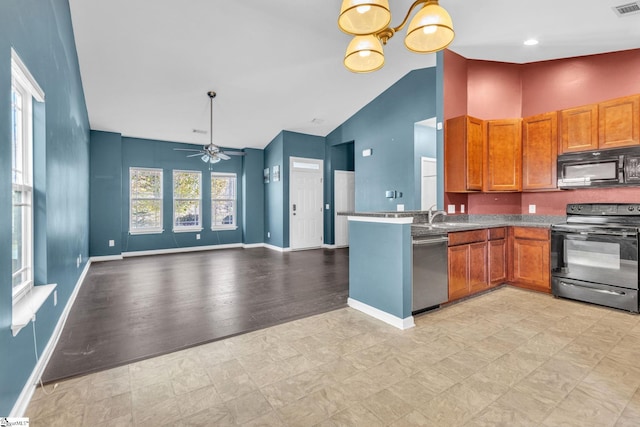 kitchen with a healthy amount of sunlight, black appliances, ceiling fan with notable chandelier, and light hardwood / wood-style floors