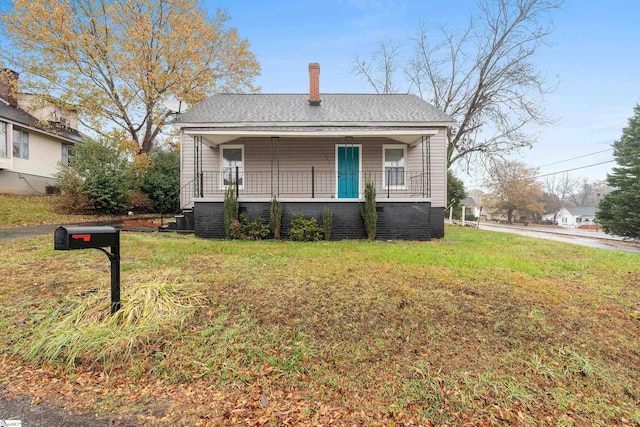 bungalow with a porch and a front yard