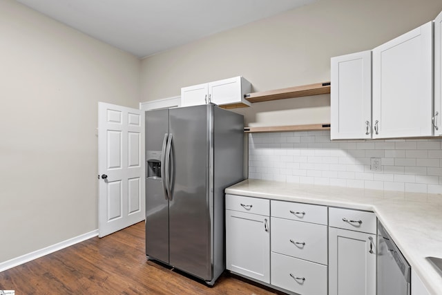 kitchen featuring white cabinets, backsplash, stainless steel appliances, and dark wood-type flooring