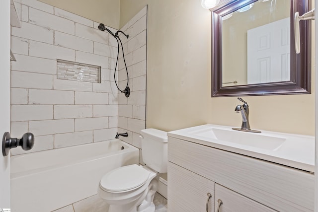 full bathroom featuring tile patterned floors, tiled shower / bath combo, toilet, and vanity