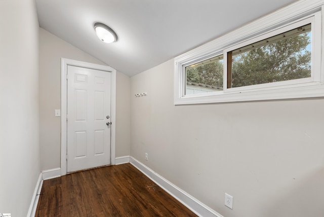 doorway to outside featuring dark hardwood / wood-style floors and vaulted ceiling
