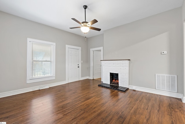 unfurnished living room featuring ceiling fan, a fireplace, and dark hardwood / wood-style floors