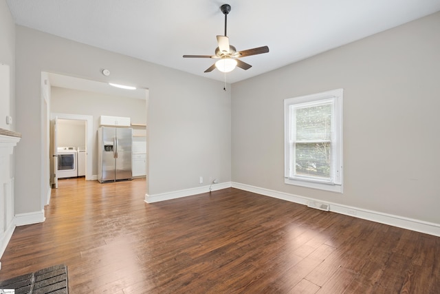 spare room with ceiling fan, washer and clothes dryer, and hardwood / wood-style flooring