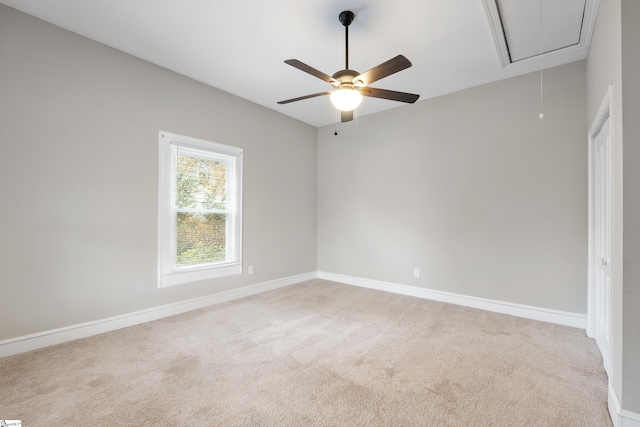 empty room featuring ceiling fan and light colored carpet