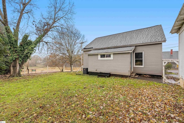 exterior space featuring a lawn and central air condition unit