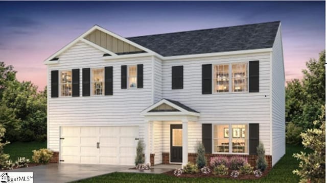 view of front of home with a lawn and a garage