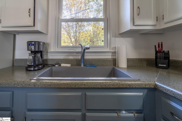 details with white cabinets and sink