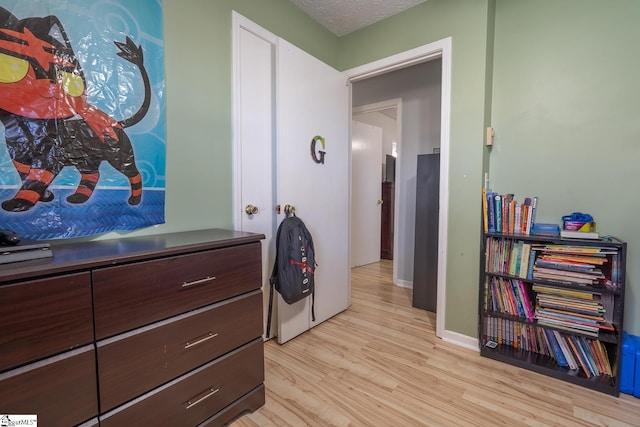 interior space featuring light hardwood / wood-style floors and a textured ceiling