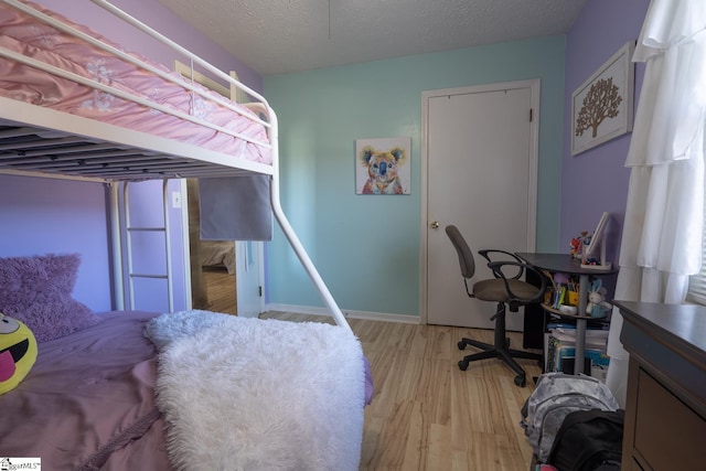 bedroom featuring a textured ceiling and light wood-type flooring