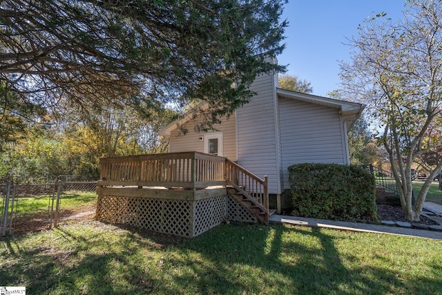 back of house featuring a yard and a deck