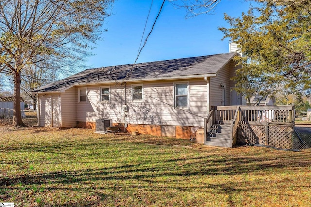 exterior space featuring a yard, a deck, and central AC unit