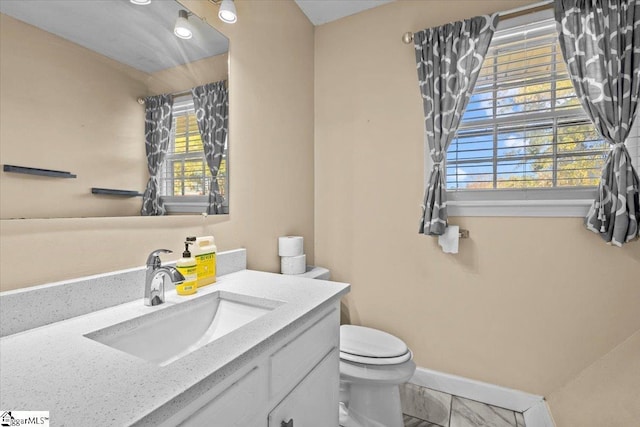 bathroom with vanity and toilet