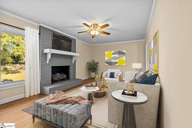 living room with a fireplace, hardwood / wood-style floors, ceiling fan, and a healthy amount of sunlight