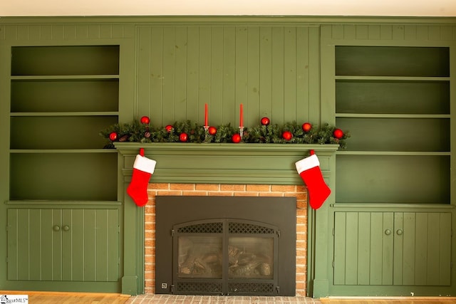 room details with built in features, a fireplace, and wooden walls