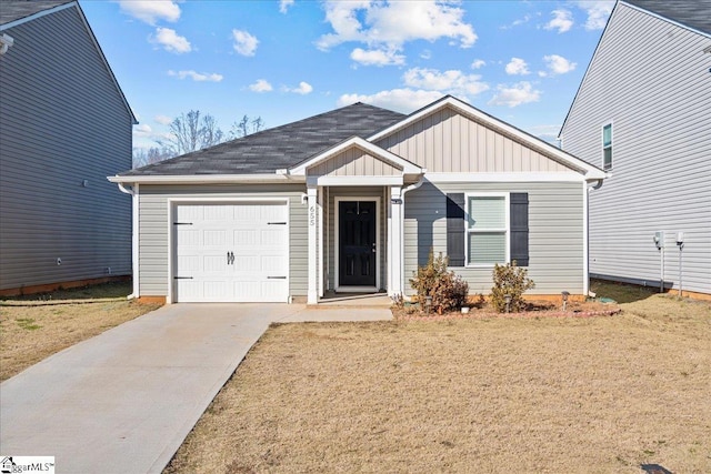 view of front of house with a garage and a front lawn