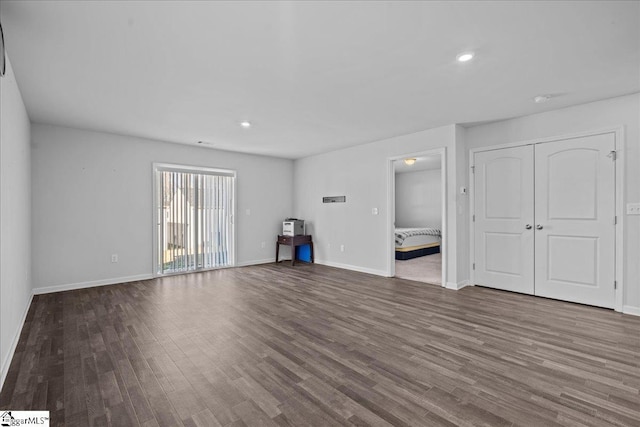 unfurnished living room featuring dark wood-type flooring