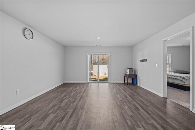 unfurnished living room with dark hardwood / wood-style flooring