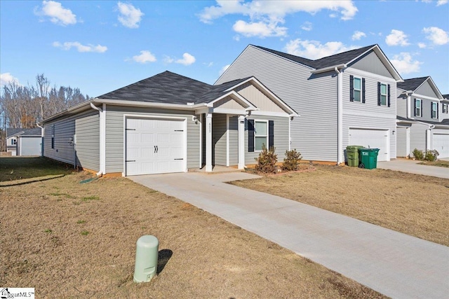 view of front of property featuring a garage and a front yard